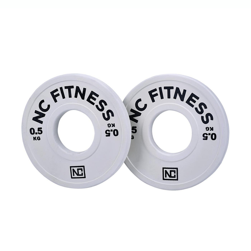 Pair of white NC Fitness 0.5kg fractional weight plates for gym training.