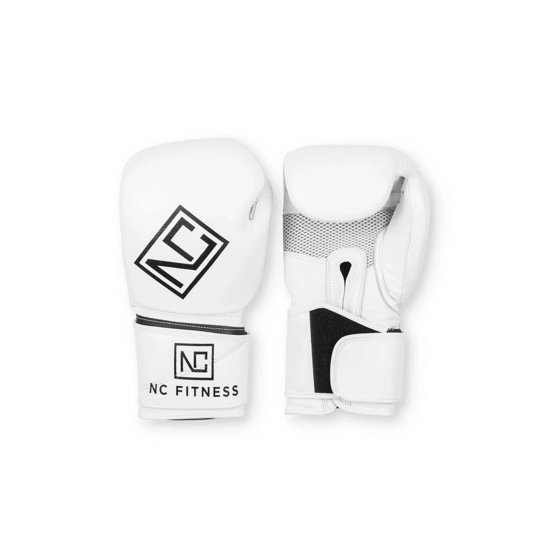 White professional boxing gloves with NC Fitness logo on a white background.
