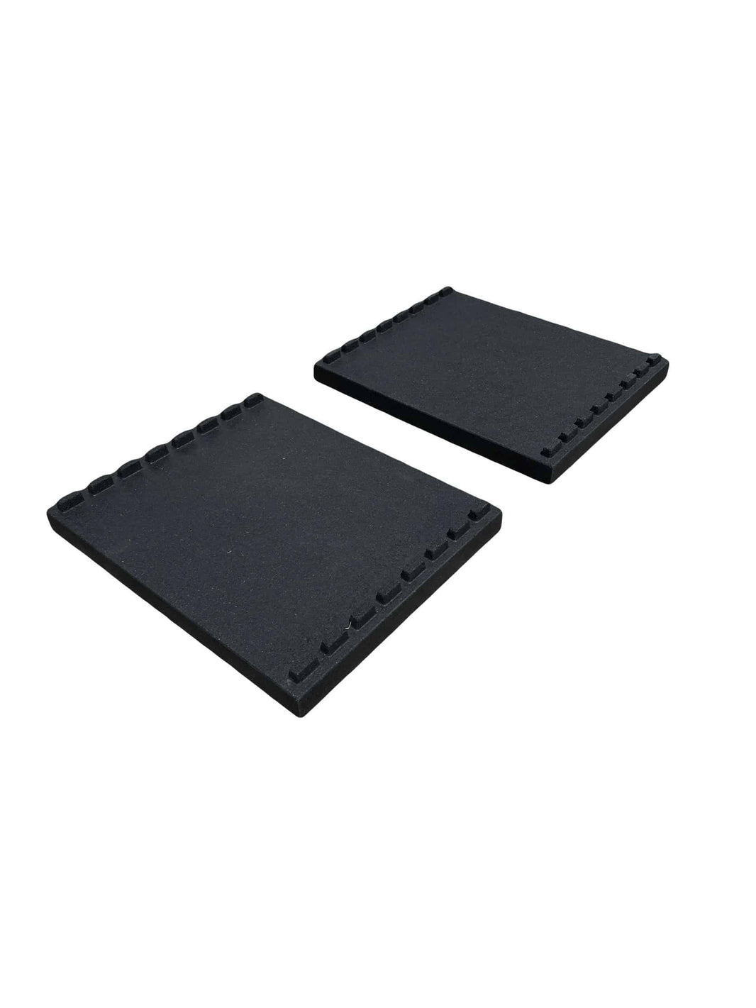 Two black rectangular rubber gym floor mats with notched edges for weight plates.