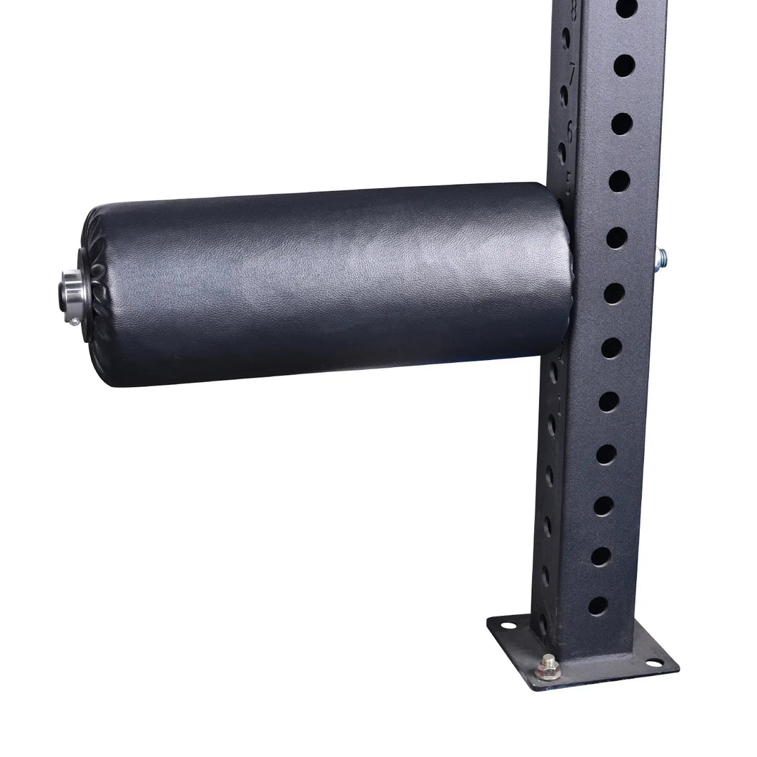 Black padded leg developer attachment for commercial gym strength training equipment.
