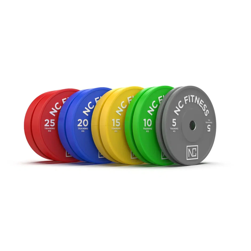 Set of colorful NC Fitness bumper weight plates in red, blue, yellow, green, and grey.