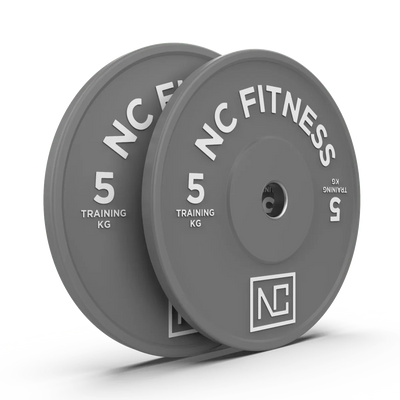 Two grey 5kg NC Fitness training weight plates for gym workouts.