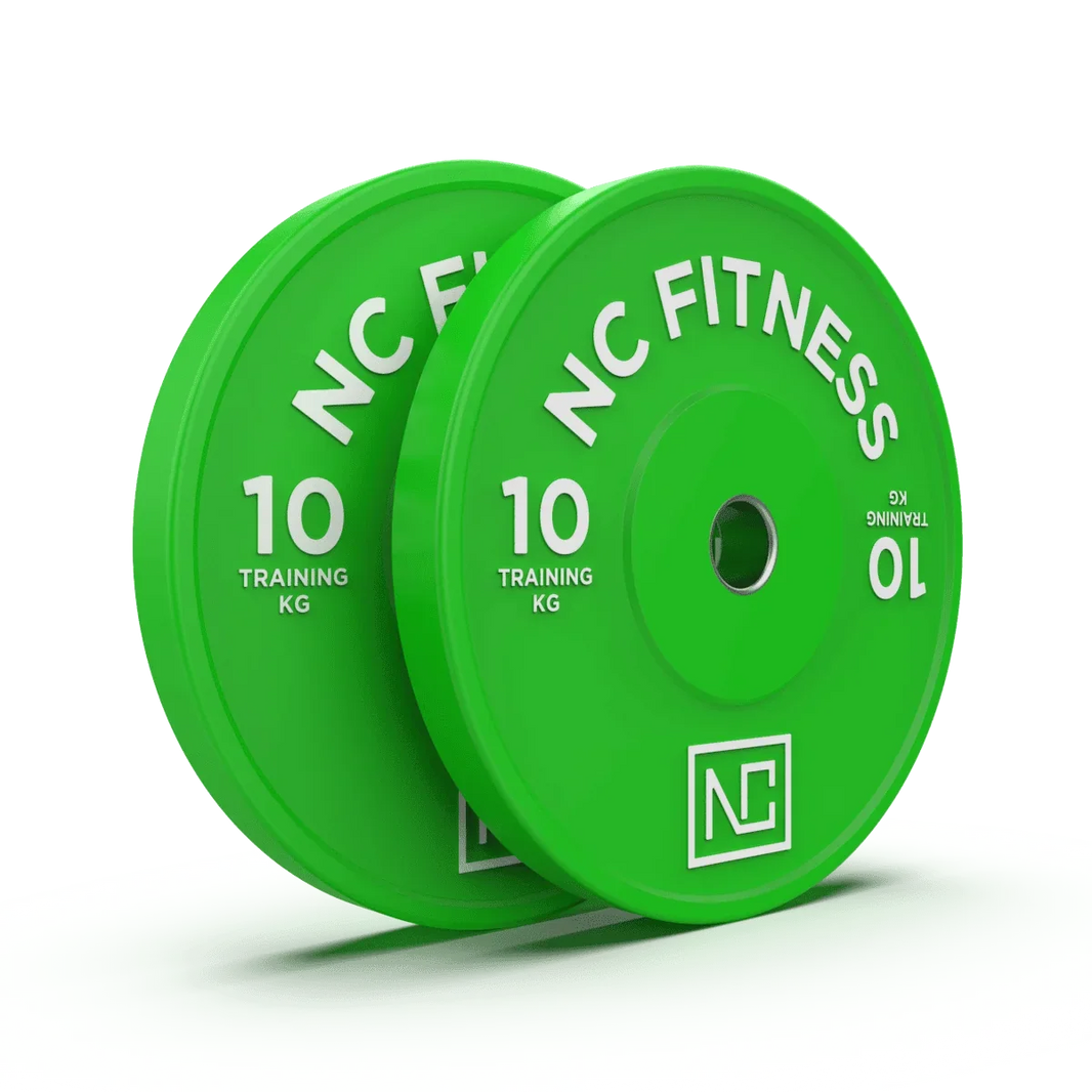 Two green NC Fitness 10kg training weight plates on a white surface.