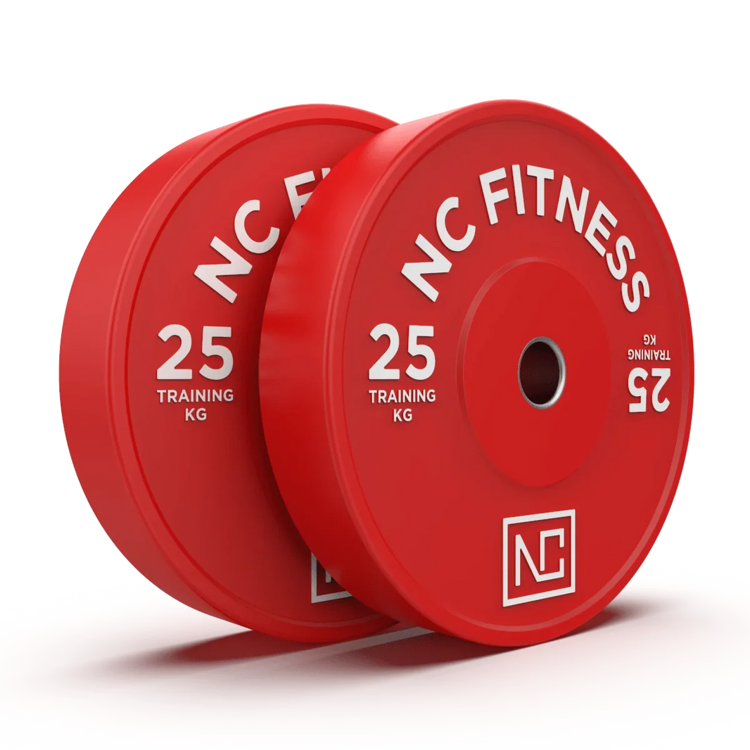 Two red NC Fitness 25kg training weight plates on a white surface against a green background.