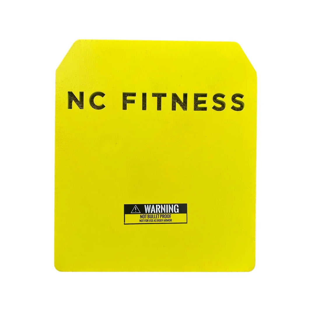 Yellow NC Fitness training target plate with warning label for strength training.