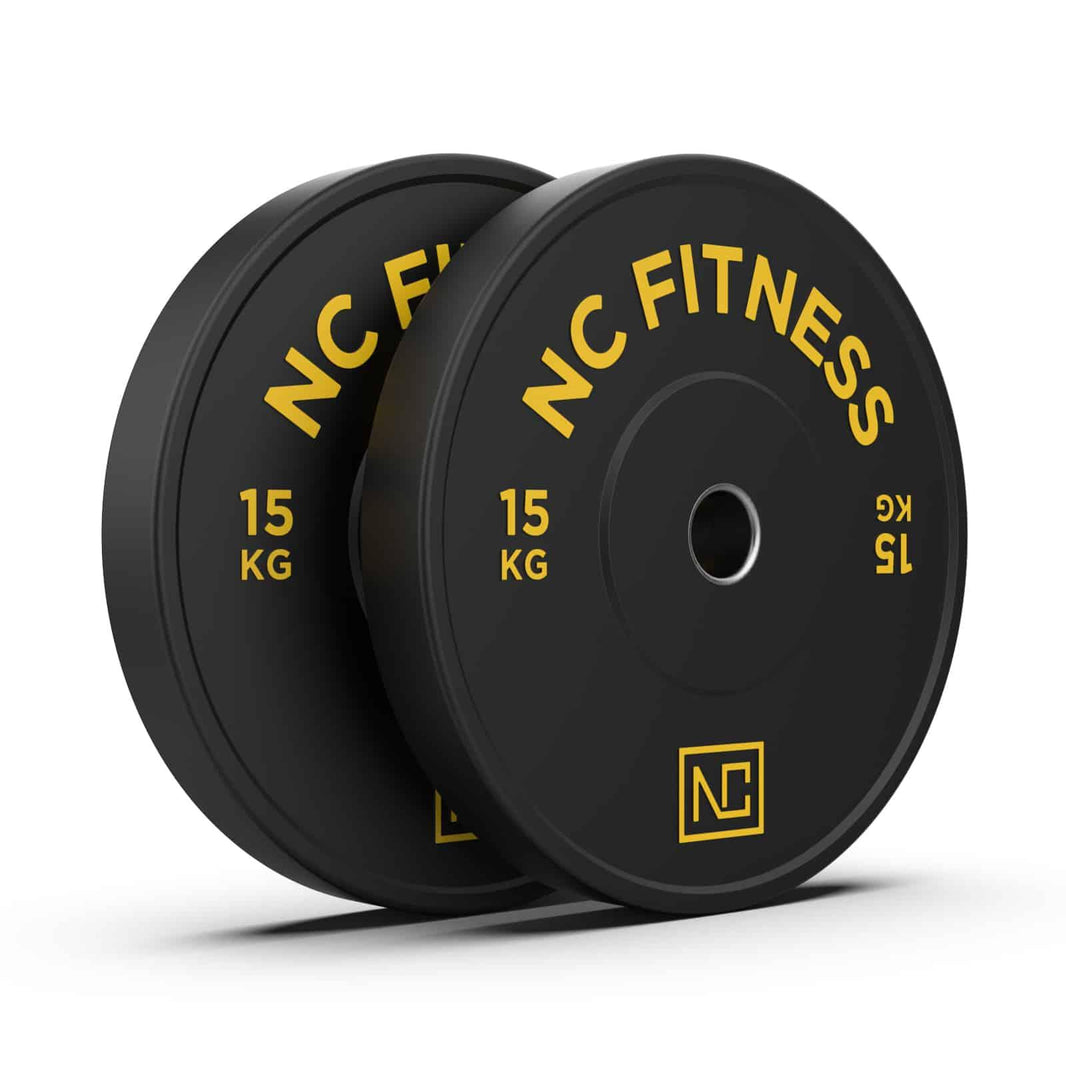 Two black NC Fitness 15kg weight plates with yellow lettering on a white background.