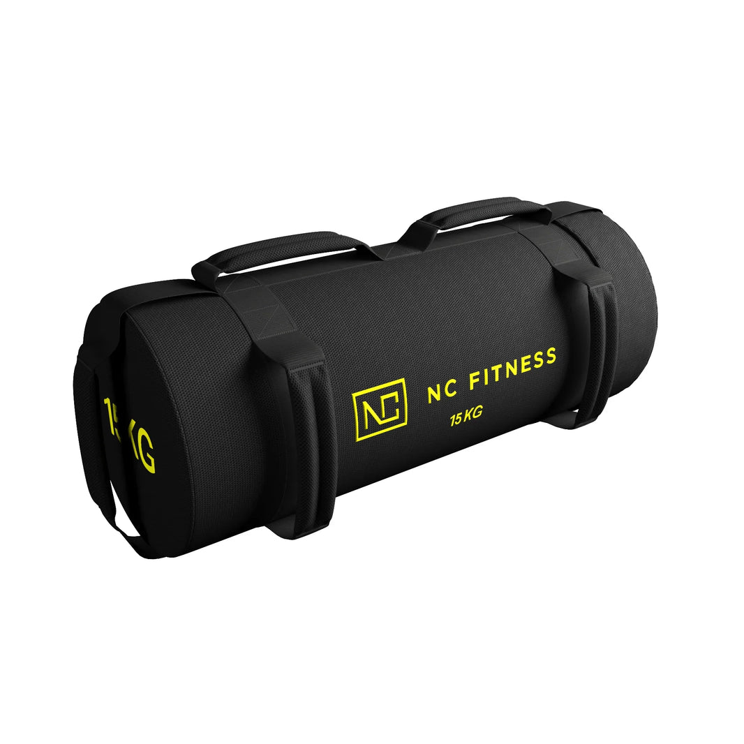 NC Fitness 15kg V2 black power bag with yellow branding for strength training.