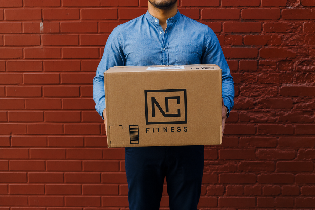 Man holding an NC Fitness delivery